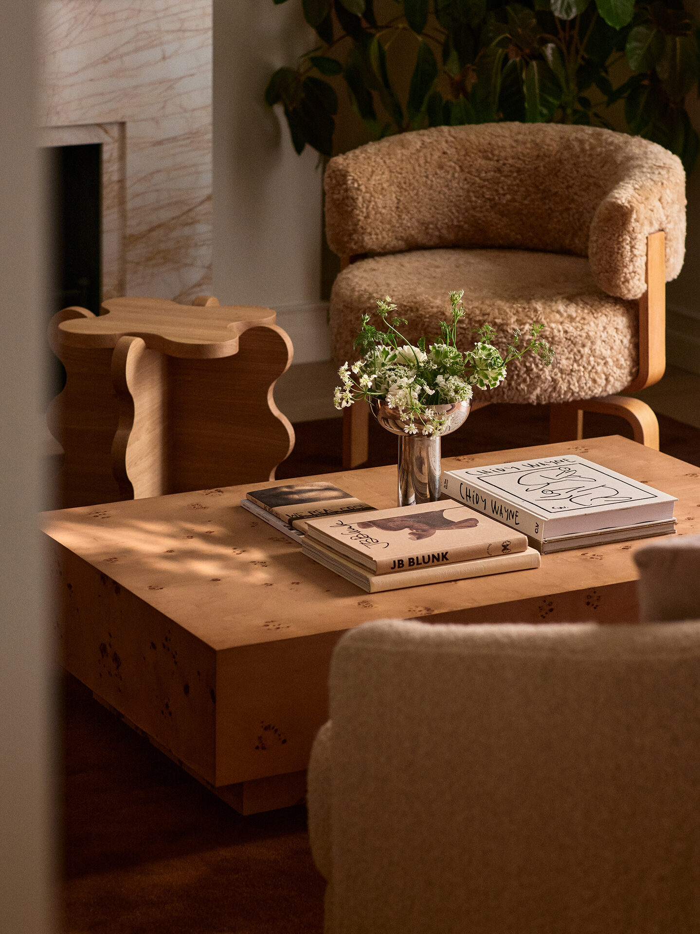 Bouclé chair and travertine coffee table