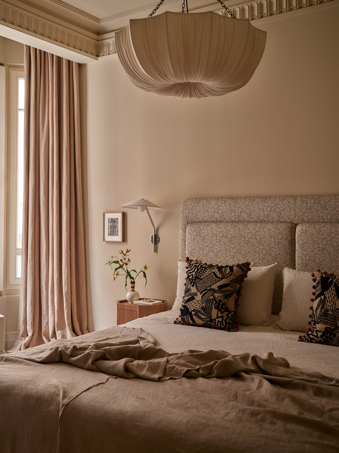 Principal bedroom with linen and patterned cushions