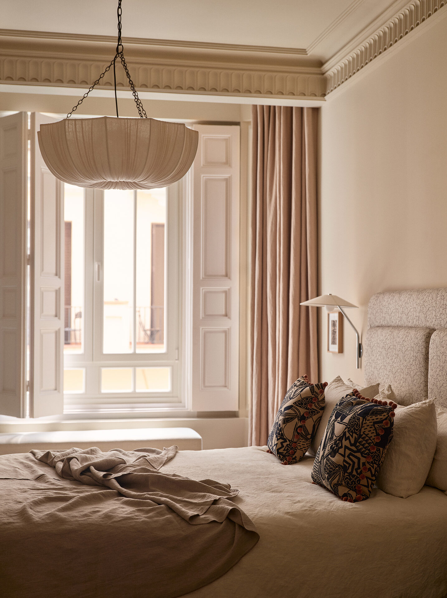 Principal bedroom with chandelier and tall window